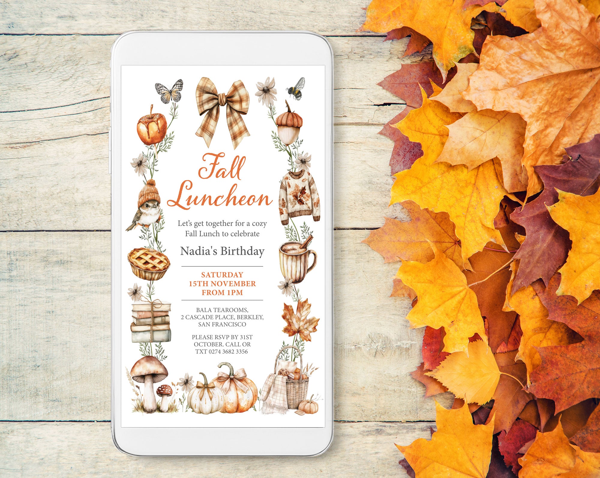 A tablet on a light wood surface displaying a Fall Luncheon invitation with autumn illustrations, surrounded by scattered orange and yellow fall leaves.