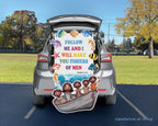 A large printed Bible-themed trunk cover and matching floor mat set displayed in the open trunk of a gray SUV on a parking lot, with a grassy field and trees in the background. The print features colorful sea creatures, a starfish, Jesus and the four disciples in a boat, and the text 'FOLLOW ME AND I WILL MAKE YOU FISHERS OF MEN' and 'Matthew 4:19'.
