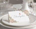 Pink & White Flower Name Place / Food Card sitting on a white plate on a table, matches the jane austen products