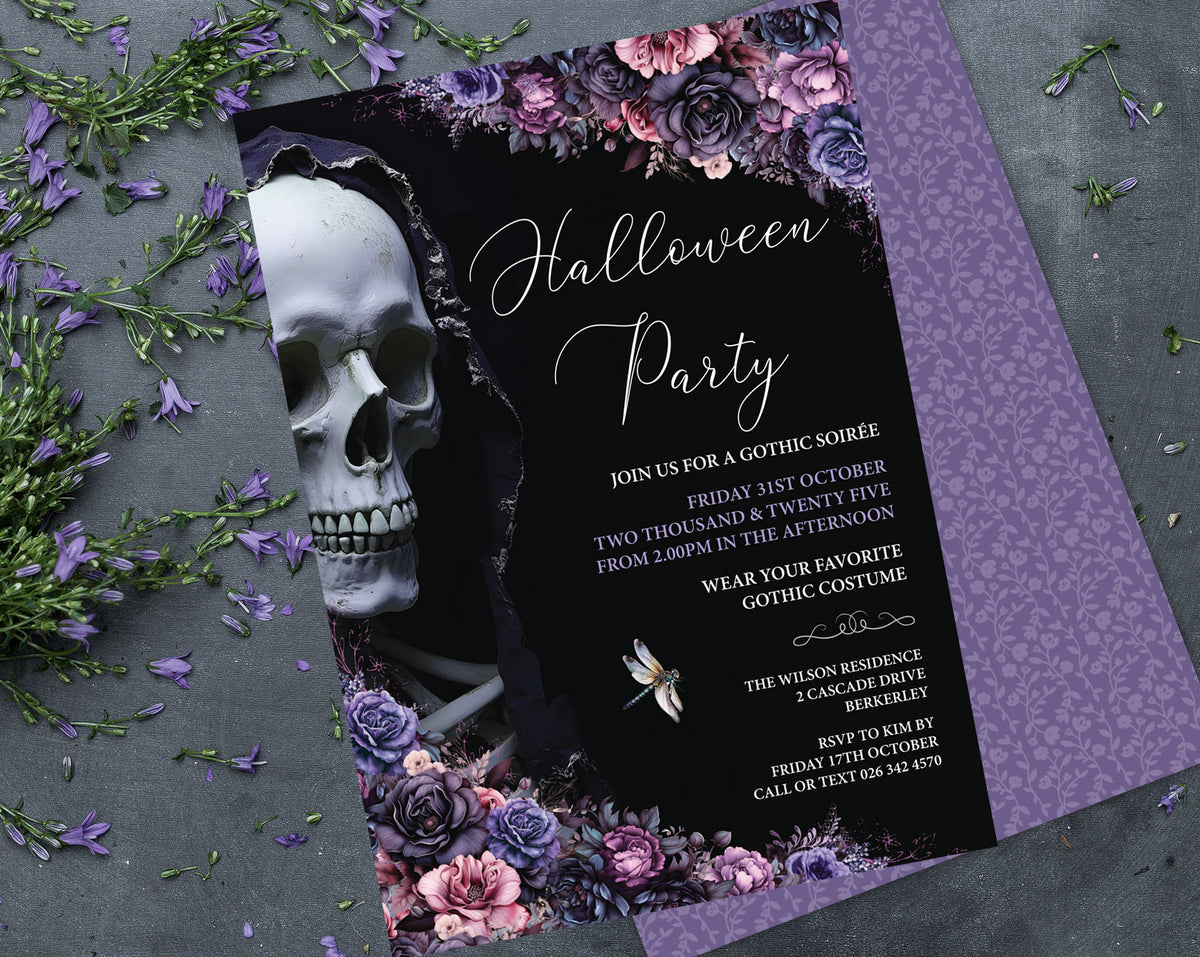 A gothic-themed Halloween party invitation card with a black background, white script text, a large white skull illustration, and purple floral borders, styled on a gray surface with scattered purple flowers and greenery.