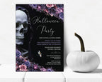 A gothic-themed Halloween party invitation card displayed on a white surface next to a white decorative pumpkin. The invitation features a black background with a large white skull, purple and pink floral borders, and white script text reading 'Halloween Party'.