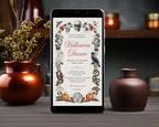 A smartphone centered on a wooden table, displaying a Halloween dinner invitation with vintage-style illustrations including a skull, crows, mushrooms, pumpkins, and floral borders. Bronze and brown ceramic vases and dried branches frame the scene in a styled indoor setting.
