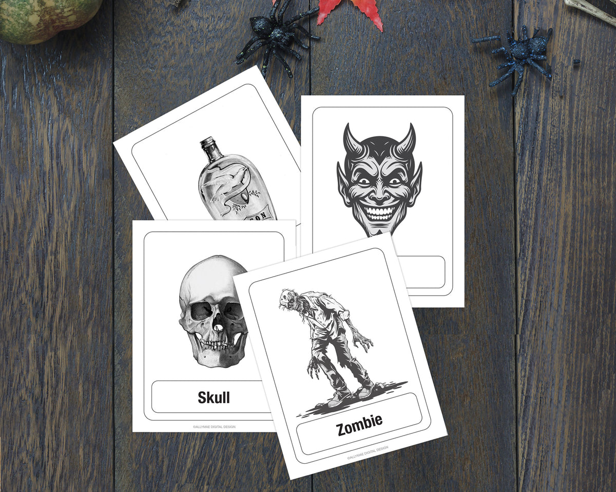 Four Halloween-themed flashcards with black and white illustrations (bottle, devil face, skull, zombie) arranged on a dark wood background with spider decorations.
