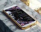 A gold-framed smartphone lying diagonally on a white and gray marble surface, displaying a Halloween party invitation design with a skull, flowers, and gothic text.
