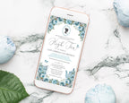 Phone displaying a high tea invitation on a marble gold rimmed mobile with a dusty blue afternoon tea invitation displaying on it surface with decorative flowers and a leaf.
