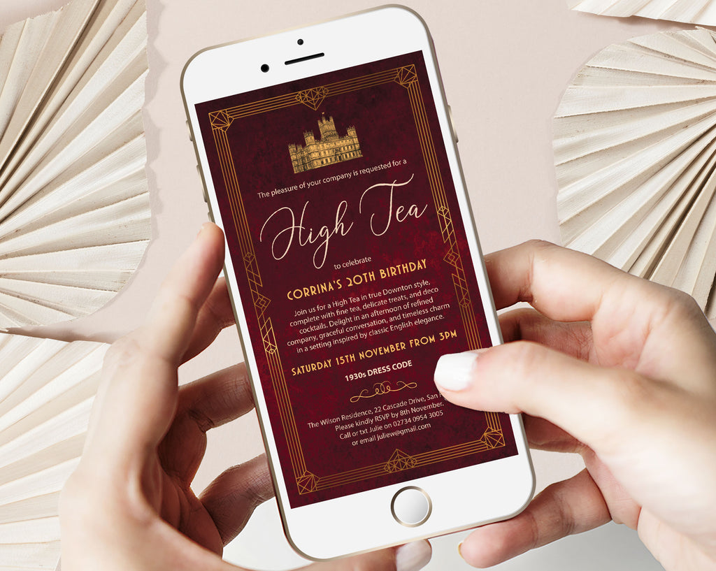 Downton Abbey Inspired Invitation showing on the screen of a mobile phone held by two hands in front of a plain background with dried flowers
