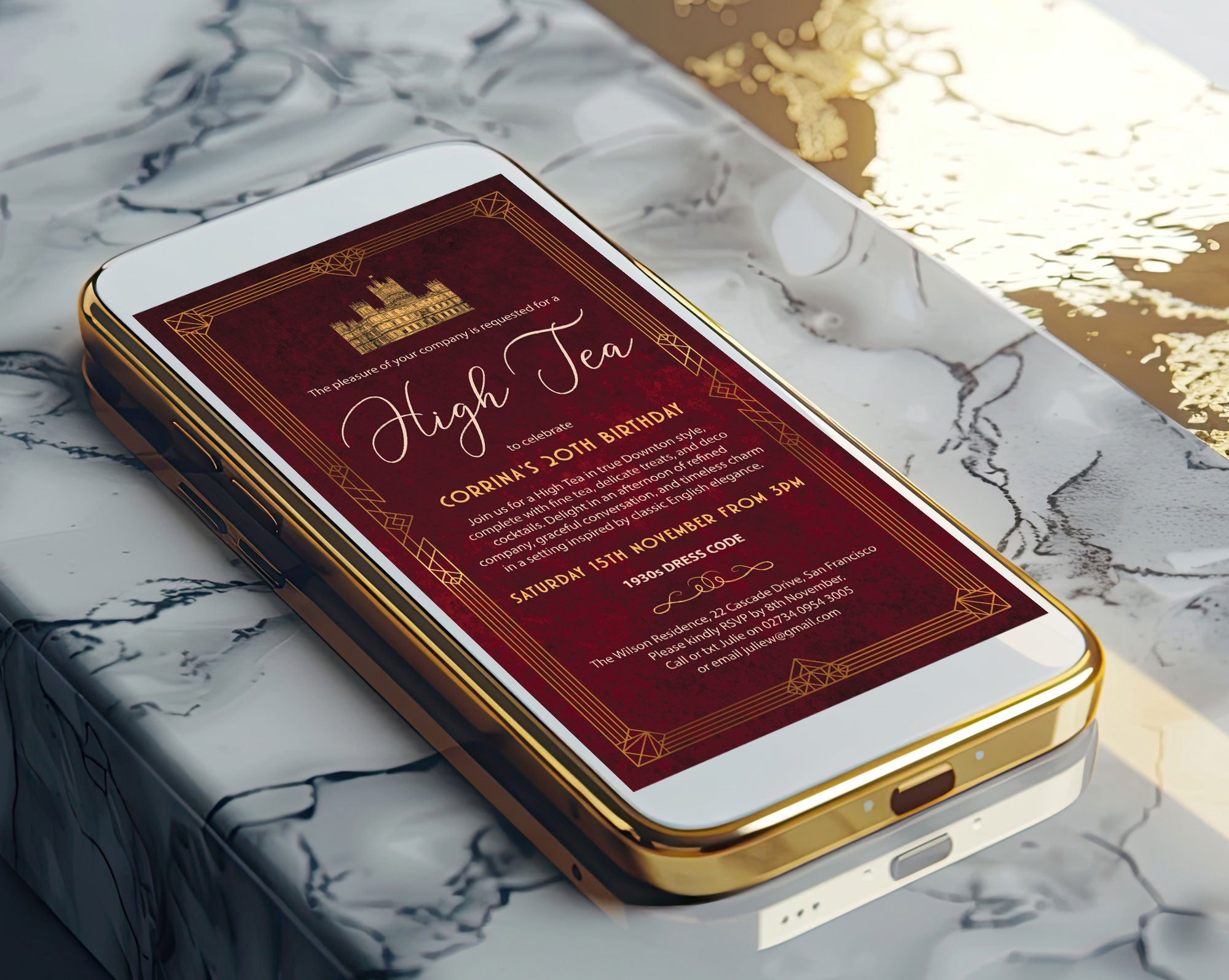 a gold mobile phone laying on a marble background with a Downton High Tea Art Deco Styled invitation showing on the screen