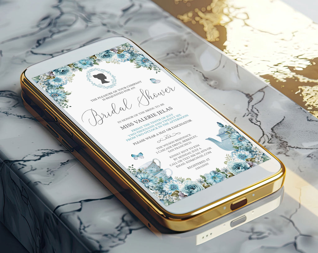 A gold mobile phone showing a pretty dusty blue bridal shower victorian style invitation on the screen laying on a marble surface
