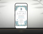 a black smart phone with a dusty blue regency style bridal shower tea invitation showing on the screen, leaning up against a white wall sitting on a black shelf