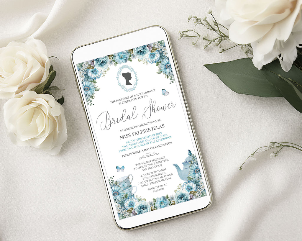 a white mobile showing a Pretty blue flower afternoon tea regency inspired invitation with cameo, laying on a white cloth surrounded by cream flowers