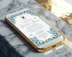 A gold mobile phone showing a pretty dusty blue bridal shower victorian style invitation on the screen laying on a marble surface
