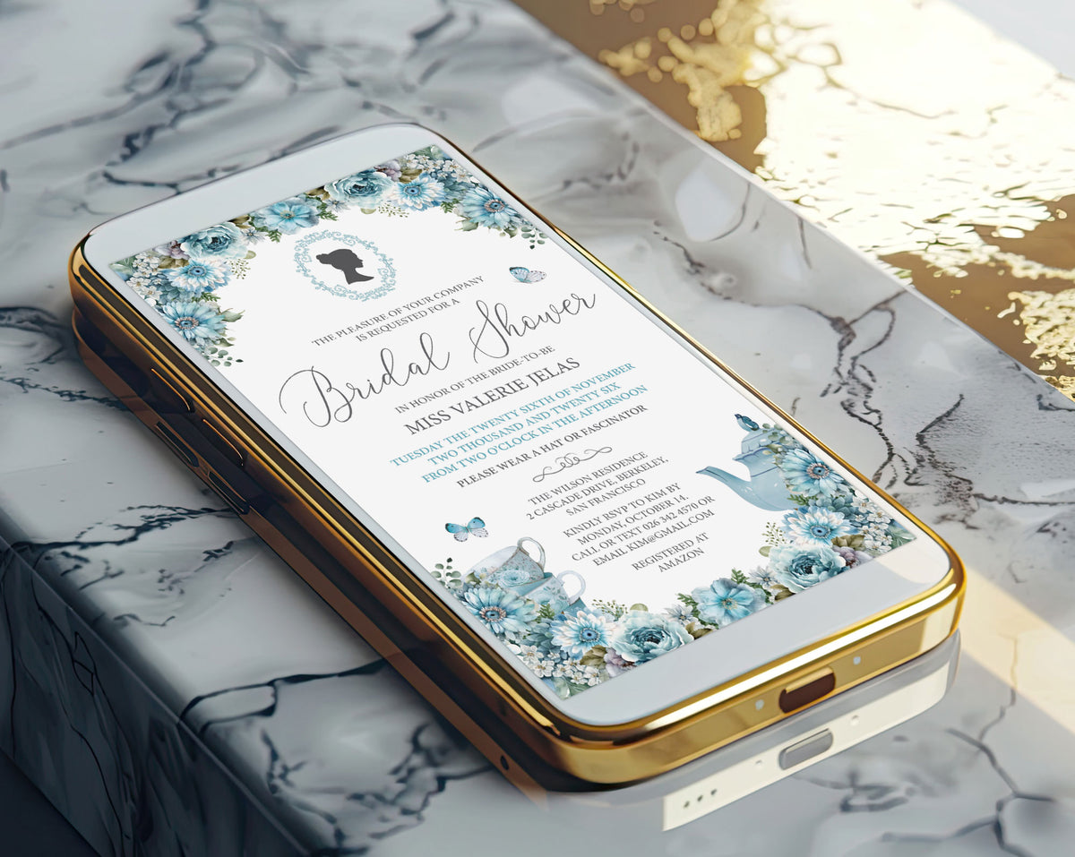 A gold mobile phone showing a pretty dusty blue bridal shower victorian style invitation on the screen laying on a marble surface