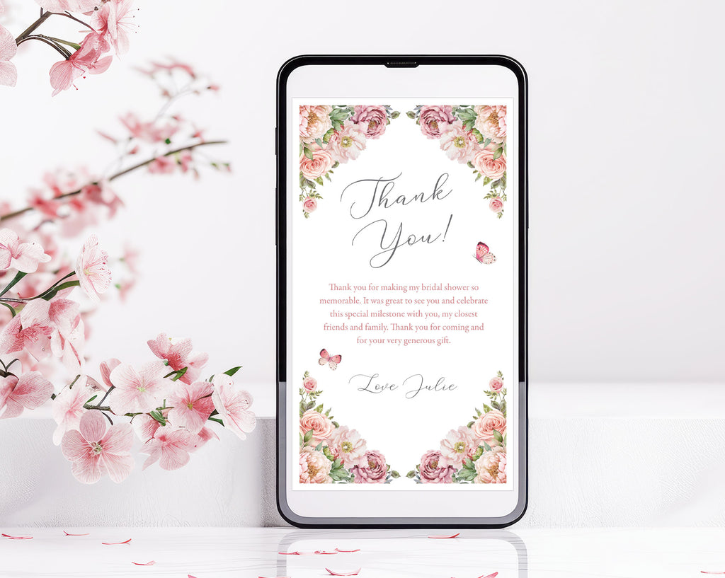 Phone screen displaying a floral 'Thank You' message standing upright next to cherry blossoms on a white background