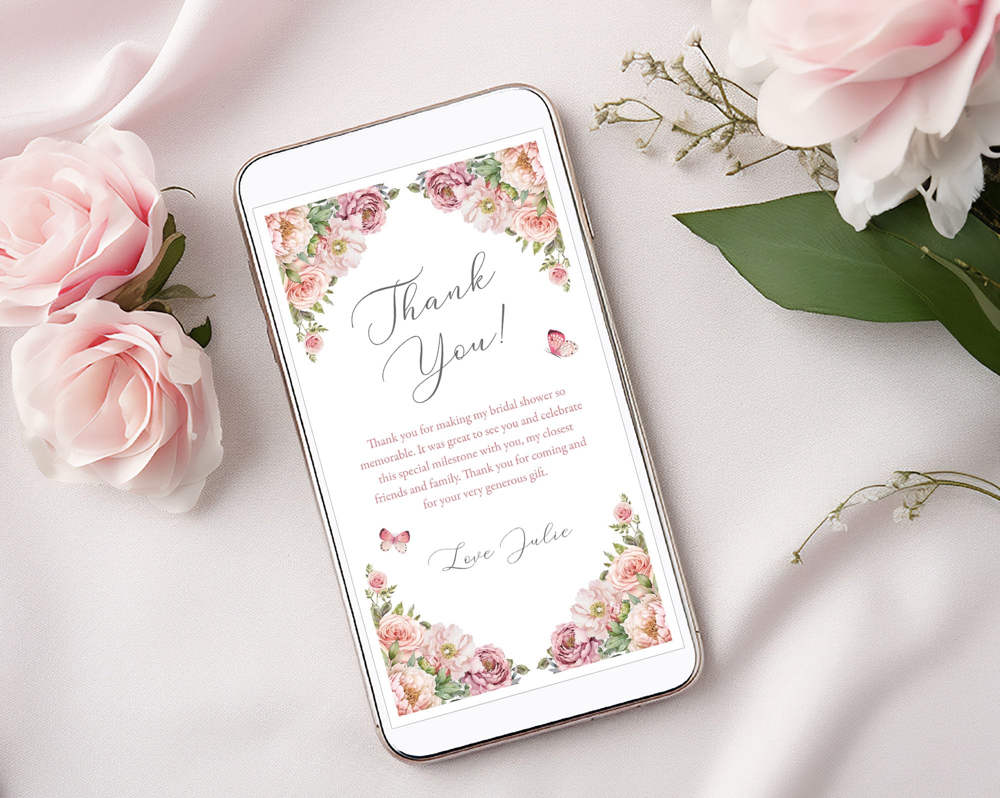 Phone with a thank you note floral design on a light background with blush pink flowers