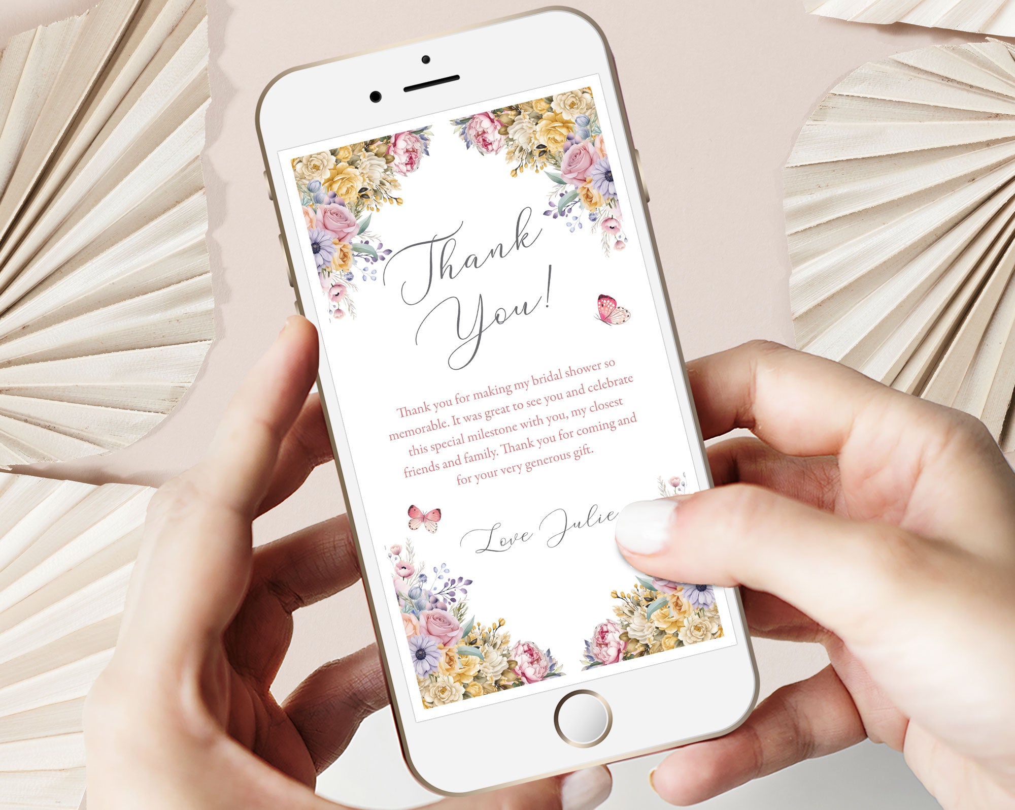 2 hands holding a mobile Phone displaying a pastel flower 'Thank You' card with text on a light background