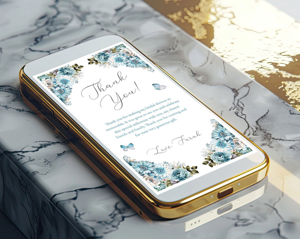 gold mobile phone lying on an angle on a marble bench top with a dusty blue flower thank you note showing on the screen