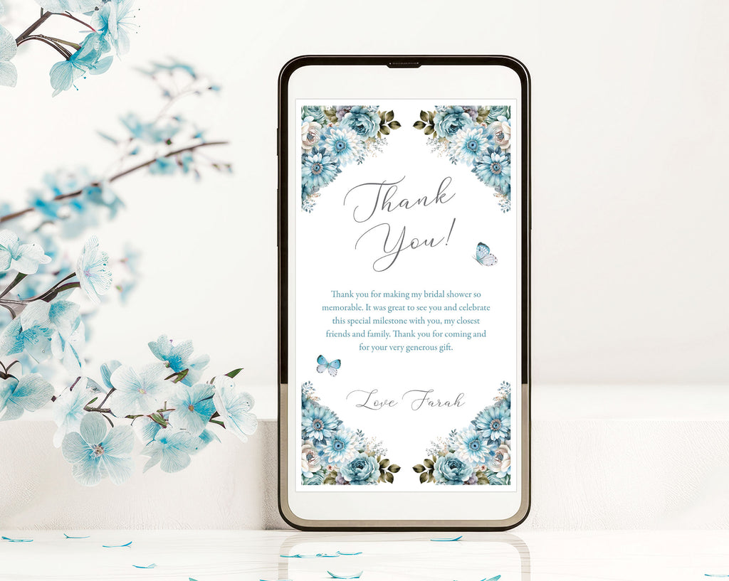 dusty blue thank you note with butterflies showing on the screen on a black mobile phone leaning against a white background next to some blue blossoms