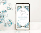 dusty blue thank you note with butterflies showing on the screen on a black mobile phone leaning against a white background next to some blue blossoms