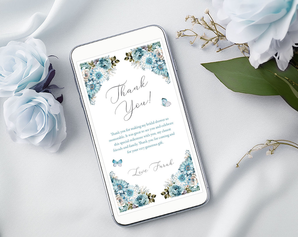 white mobile phone with a dusty blue thank you note on the screen surrounded by light blue roses on a white background