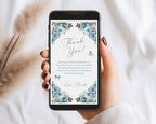 hand holding a black mobile phone over a white background with a blue flower Thank You note showing on the screen and dried flowers in the background