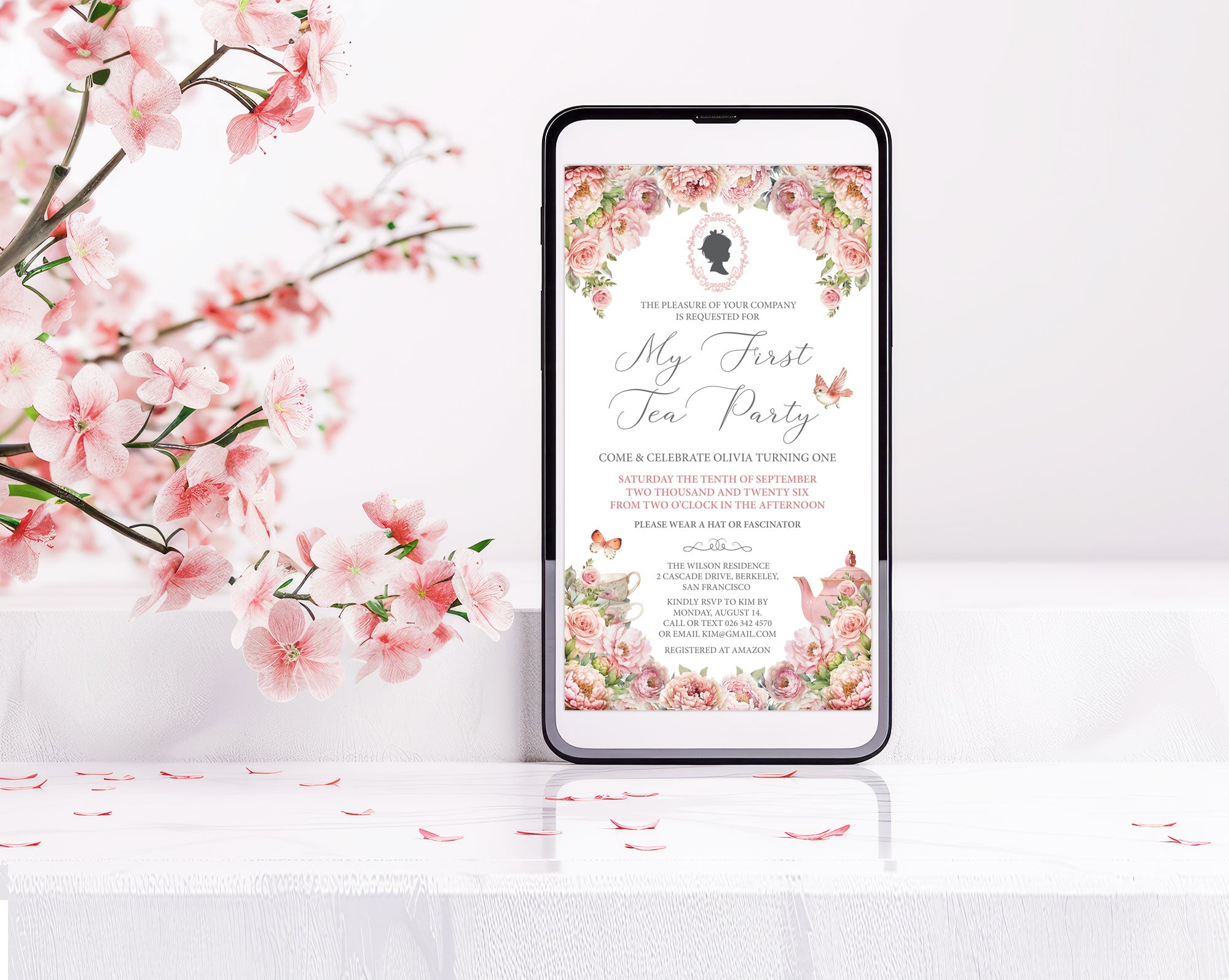 Phone displaying a floral invitation with cherry blossoms on a white background