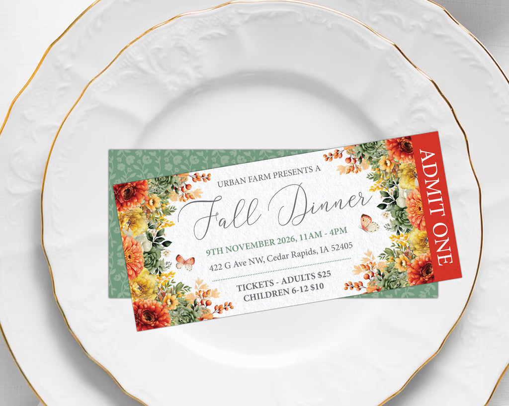 A printed event ticket for an 'Urban Farm Presents Fall Dinner' displayed on a white ceramic plate with gold trim, with another white plate behind it.