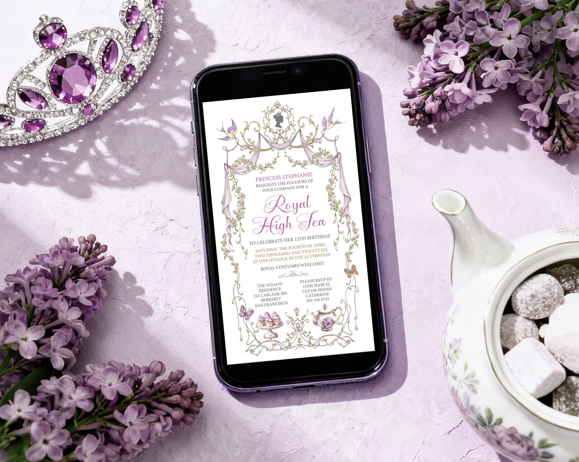 Phone displaying a 'Royal High Tea' invitation with birds, butterflies, teapot and cakes next to purple flowers, tiara and a teapot in the background