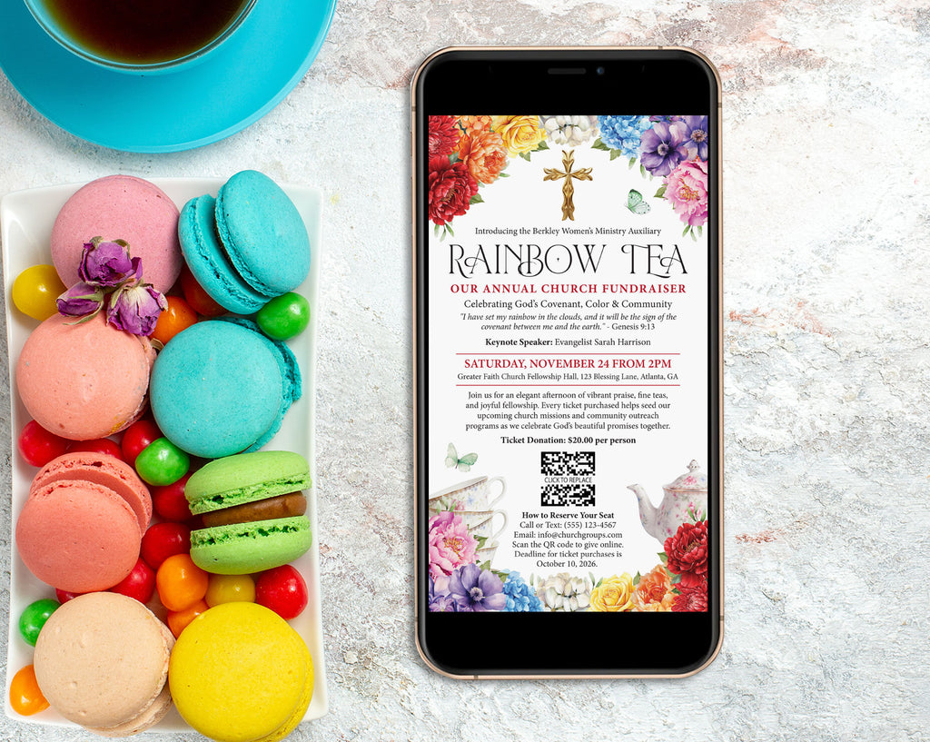 A smartphone centered on a light stone surface, displaying a church fundraiser flyer titled 'Rainbow Tea.' To the left of the phone is a white tray filled with colorful macarons and candy, and a blue cup of tea sits at the top left.