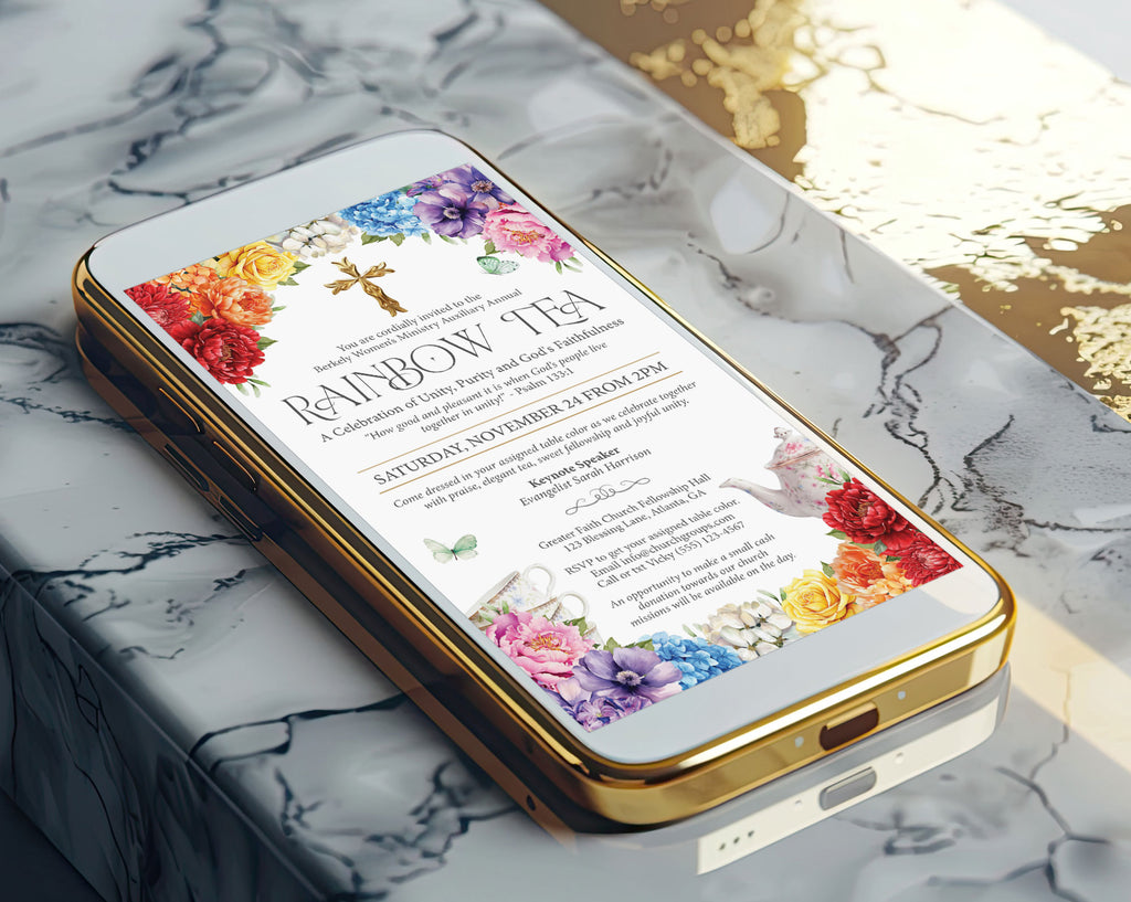 A gold mobile phone showing a pretty church rainbow tea invitation laying on a marble surface
