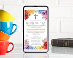 4 bright stacked cups next to a black mobile phone with a rainbow tea church event invitation showing on the screen and a bible on the right hand side