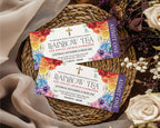 2 rainbow tea church event admit one tickets on a rattan mat with pretty flowers and a beige cloth