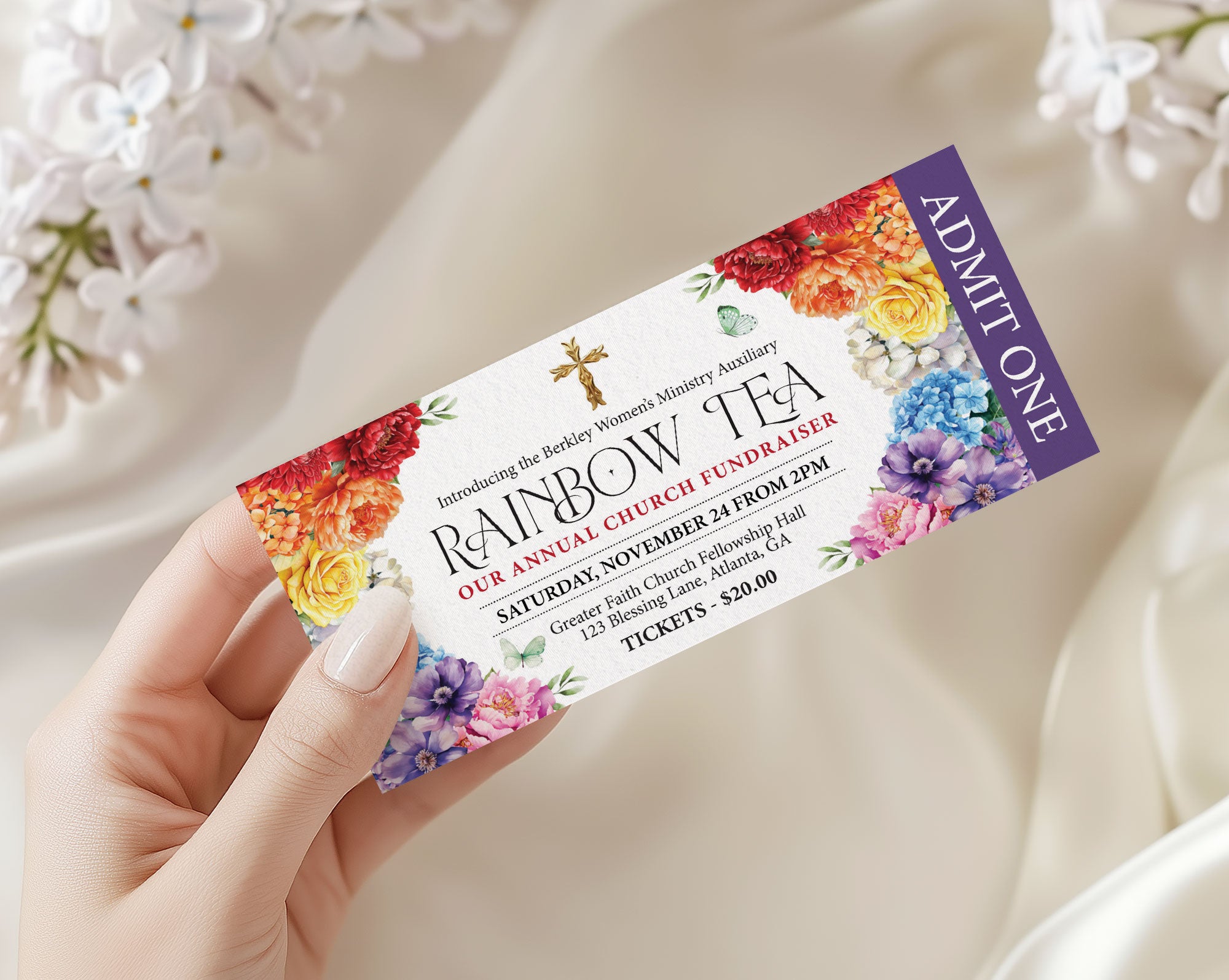 a lady's hand holding an elegant rainbow tea party church event ticket with a white background and some flowers