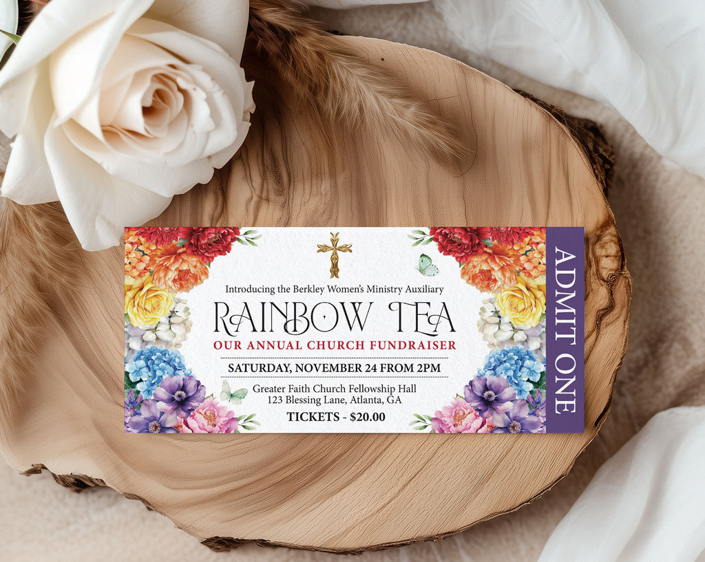 pretty church rainbow tea  ticket with butterflies and gold cross laying on a wooden board with a white rose