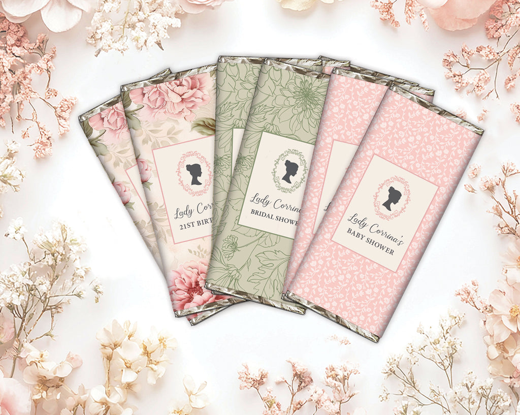 6 elegant chocolate bars with pretty pastel pink, green and floral wrappers on a white background with blush pink flowers