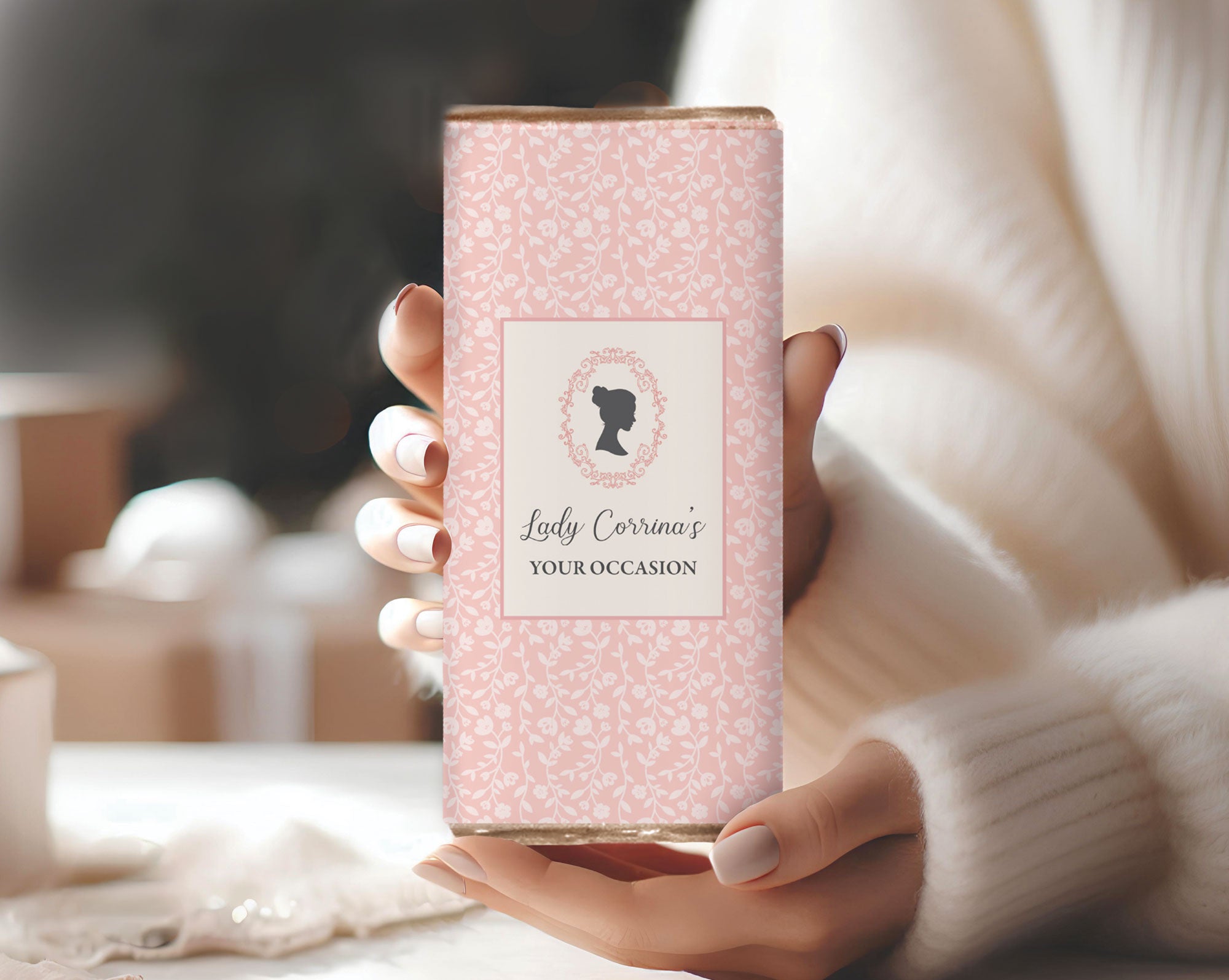 Hand holding a pink regency styled chocolate bar with cameo and editable text