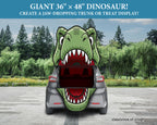A car trunk shown from the back with a large green dinosaur head graphic printed across it, set in a paved outdoor area with trees. Text at the top reads 'GIANT 36" x 48" DINOSAUR! CREATE A JAW-DROPPING TRUNK OR TREAT DISPLAY!' and 'simulation of setup' appears at the bottom right.