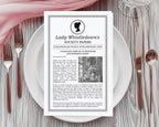 4 Page, black and white folded Corjl Whistledown Society Scandal Leaflet with cameo, laying on a white plate with cutlery and gauzy pink cloth at the top