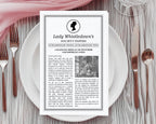 A printed vintage-style paper titled "Lady Whistledown's Society Papers" with Afro American cameo is laid flat on a white plate, surrounded by silverware and a pink napkin on a gray wood surface.