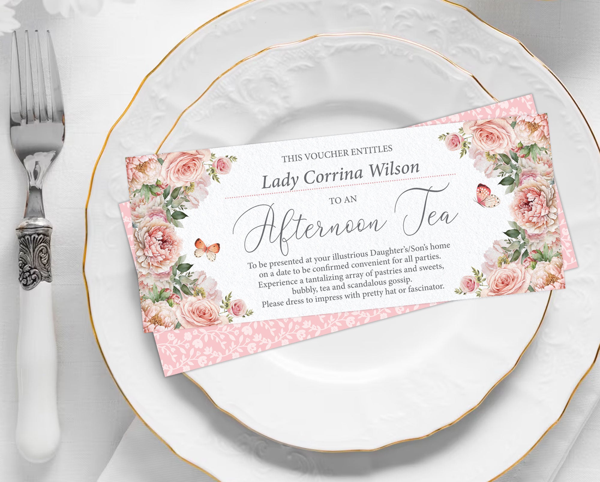 pretty blush pink Floral voucher on a white plate with silverware