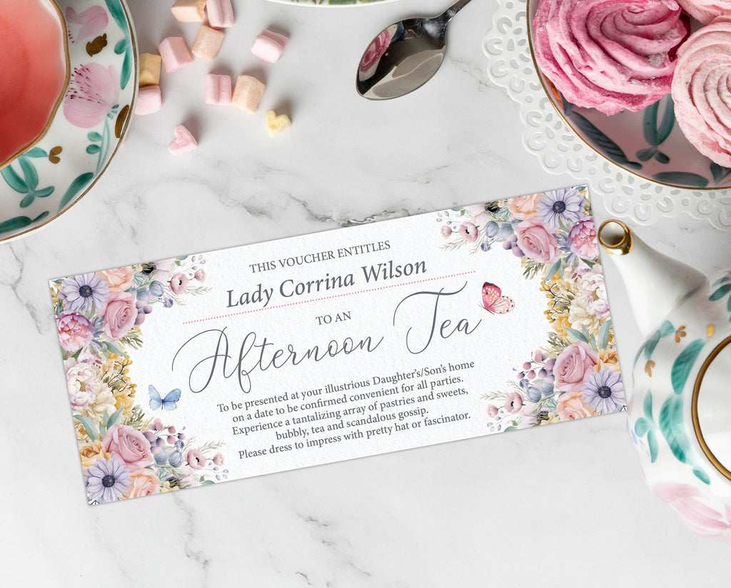 Afternoon tea voucher with floral design on a marble surface with tea set items.