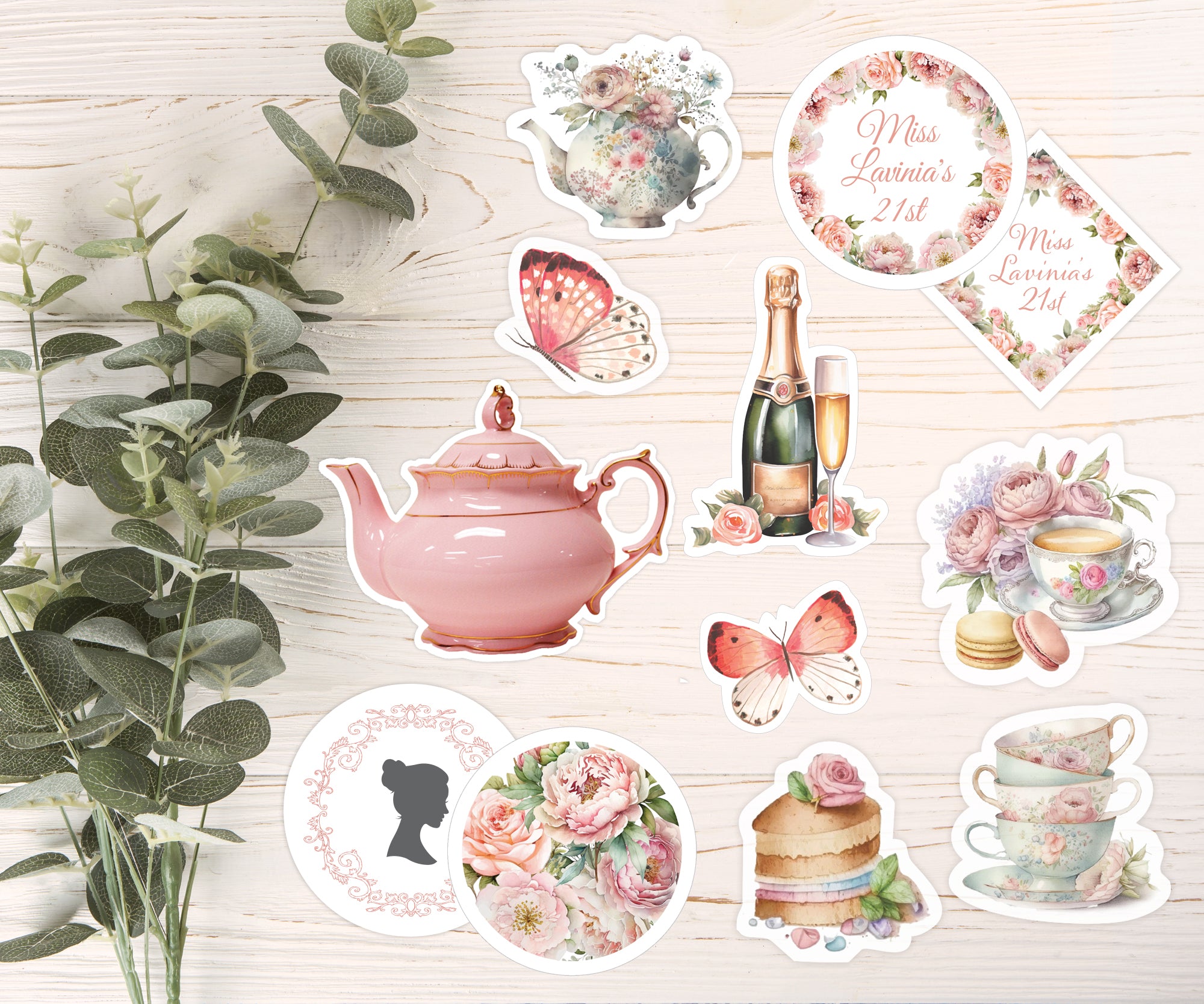 Collection of decorative stickers or cake toppers featuring teapots, flowers, and other elements on a wooden surface.